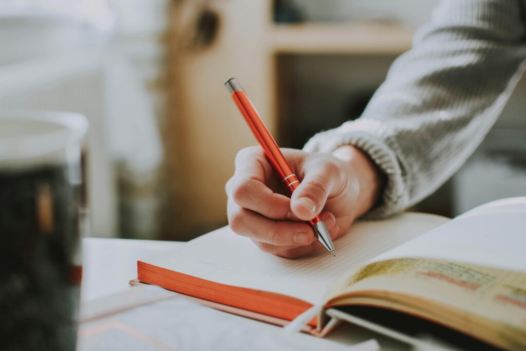 Individual reflecting on personal setbacks and journaling about failure
